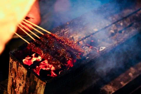The process of burning savory beef satay with spicy seasoning on the burning Stock Photos