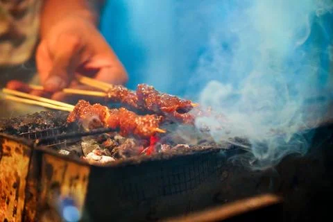 The process of burning savory beef satay with spicy seasoning on the burning Stock Photos