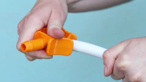 Process of calibrating plastic pipe with orange hand tool Stock-Footage 338016134
