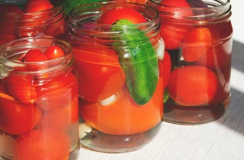The process of canning pickled tomatoes and cucumbers for the winter Stock Photos