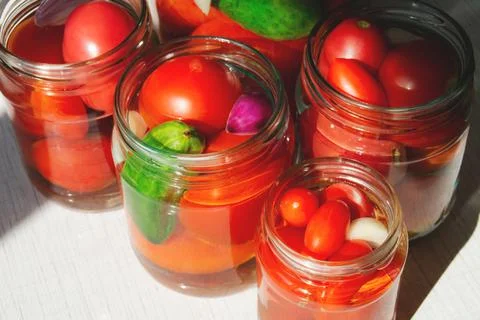 The process of canning pickled tomatoes and cucumbers for the winter Stock Photos