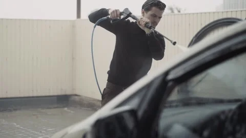 Process of car cleaning with high pressure water equipment on the self carwash Stock Footage 144676308