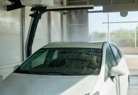 Process of car washing with driver inside Stock Photos