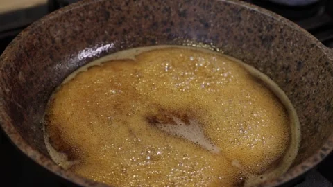 The process of caramelizing pecans in maple syrup to make pumpkin pie Stock Footage 286110546
