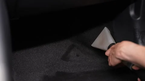 Process of careful auto maintenance detailing, male worker using wet vacuum to Stock Footage 291334674