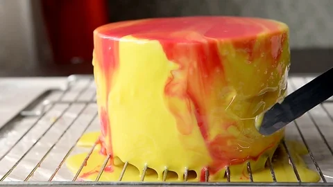 The process of casting the mirror glaze on a cake round session. Mousse.Yellow Stock Footage 76940459