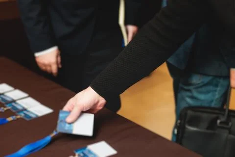 Process of checking in on a conference congress forum event, registration d.. Fotos de archivo