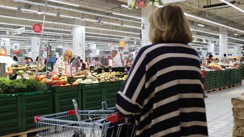 The process of choosing and buying products in a supermarket.  Stock Footage 282506645