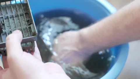 Process of cleaning aquarium filter foam in water removing dirty, microbes and Stock Footage 305049658