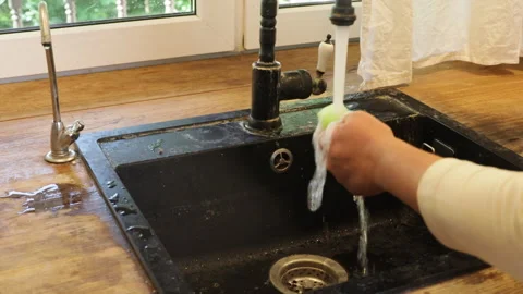 The process of cleaning a black kitchen sink Stock-Footage 282502815