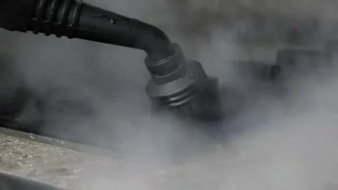 The process of cleaning the kitchen, the hob using a steam cleaner. House Stock Footage 241077174