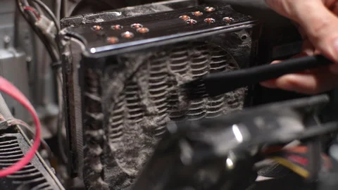 Process cleaning old dusty computer cooler inside of PC case from dust and dirt Stock Footage 277065554