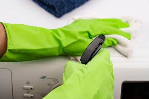 The process of cleaning a washing machine using a spray bottle and a wipe Fotos Stock