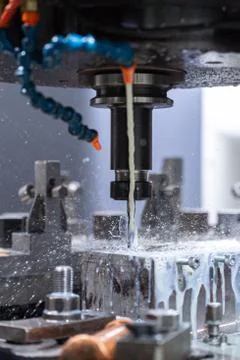 A process of cnc vertical drilling with liquid coolant flow Photos