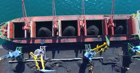 Process of coal loading into bulk cargo ship by big cargo cranes. Nakhodka bay. Video stock 65278857