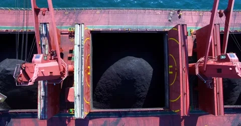 Process of coal loading into bulk cargo ship by big cargo cranes. Nakhodka bay. Video stock 65289083
