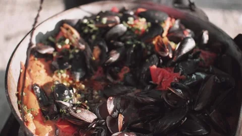 Process of cocking mussels in a massive pot outdoors Stock Footage 144815021