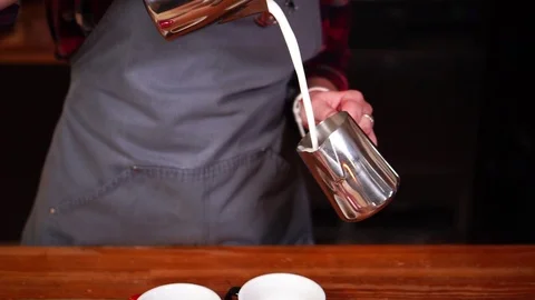 Process of coffee making in slow motion, female barista working with milk to Stock Footage 104541150