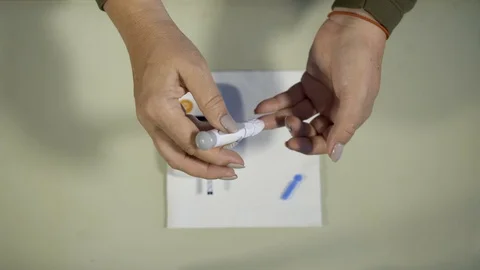 The process of collecting blood for analysis on cholesterol and sugar Stock Footage 99556778