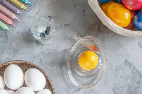 Process of coloring eggs for the Easter holiday using ampoules with dye. Diff Stock Photos