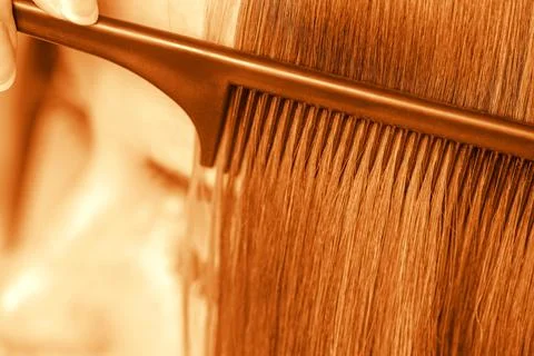 The process of combining a fine black comb for ginger hair Stock Photos