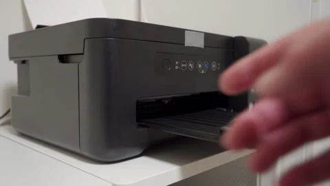 Process Commences: Hand Turns On Printer, Operational Whirring Echoing. Stock Footage 320848753