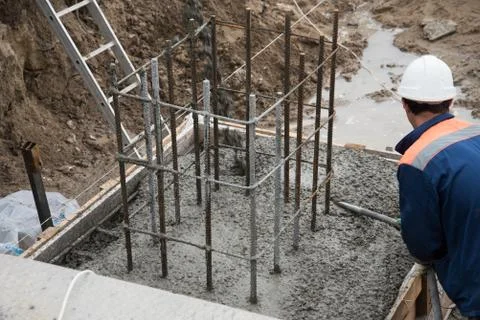 The process of compacting and smoothing fresh concrete. Concrete is poured in Stock Photos
