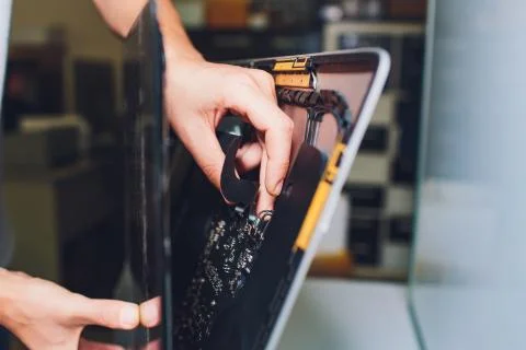 Process of computer repair. Engineer in white gloves disassembling computer. Stock Photos