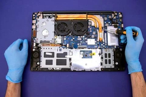 Process of computer repair. Engineer in white gloves with computer. Stock Photos