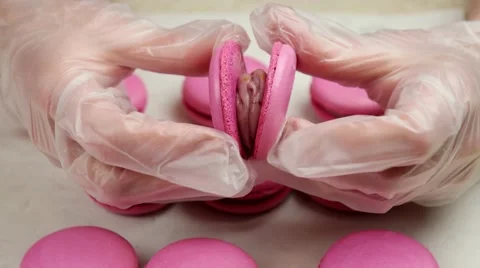 Process of connecting two halves of macaroon in the hands of chief Stock Footage 62426093