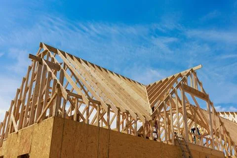 In the process of constructing house, beams are being framed. Stock Photos