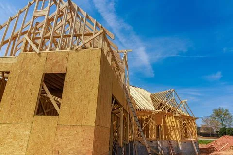 In the process of constructing house, beams are being framed. Stock Photos