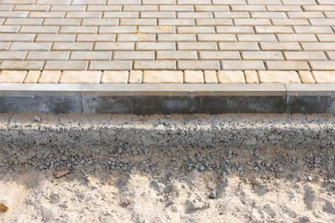 Process of construction of brick paved sidewalk Stock Photos
