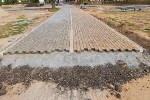 Process of construction of brick paved sidewalk Stock Photos