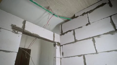 Process of construction house from the gas silicate block. A worker smears a Stock Photos