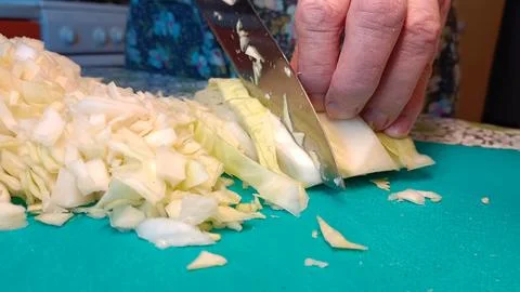 The process of cooking and cutting cabbage in a regular home kitchen Stock Photos