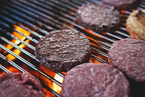 Process of cooking and grilling beef burgers on open-air street food festiv.. Stock Photos