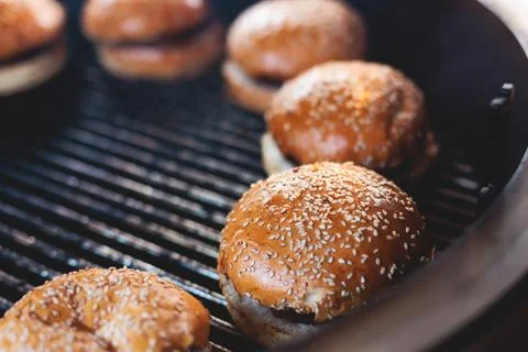 Process of cooking and grilling beef burgers on open-air street food festiv.. Stock Photos
