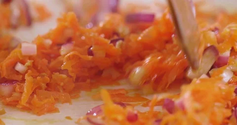 Process of cooking and stirring carrots, onions and garlic Видео 128603349
