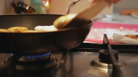 Process of cooking baked pancakes. Use fork to flip mini pancakes to other side Stock-Footage 146873073