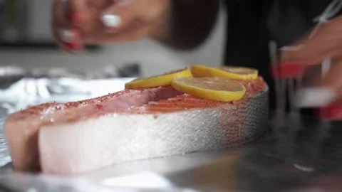 Process of cooking the baked salmon steak in foil with lemon Stock Footage 150208597
