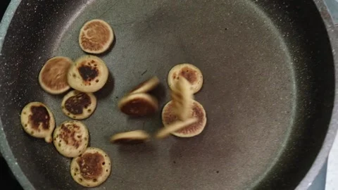 Process of cooking baked tiny pancake cereal - trendy quarantine food. 動画素材 131106504