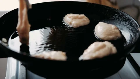 Process of cooking baked tiny pancake.  Homemade breakfast. Slow motion. Video stock 142097028