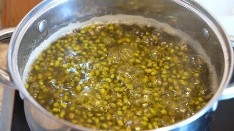 The process of cooking beans. Bean seeds in boiling water in a saucepan. Stock Footage 121843208
