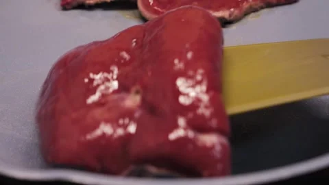 Process of cooking beef liver steaks in a frying pan at home. Stock Footage 336385493