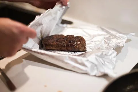 The process of cooking beef steak in a frying pan Stock Photos