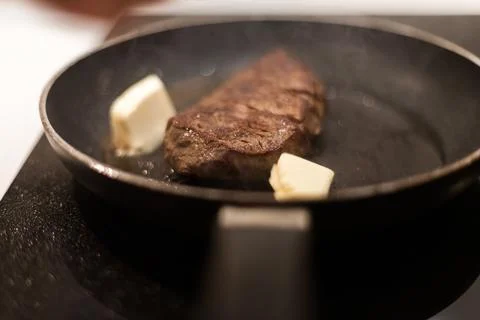 The process of cooking beef steak in a frying pan Stock Photos