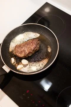 The process of cooking beef steak in a frying pan Stock Photos
