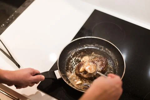 The process of cooking beef steak in a frying pan Stock-Fotos