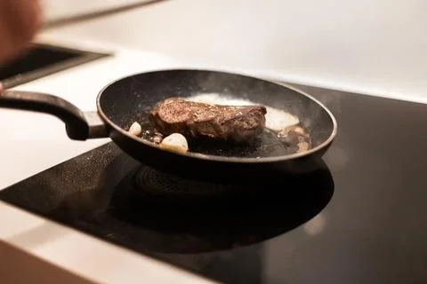 The process of cooking beef steak in a frying pan Stock Photos